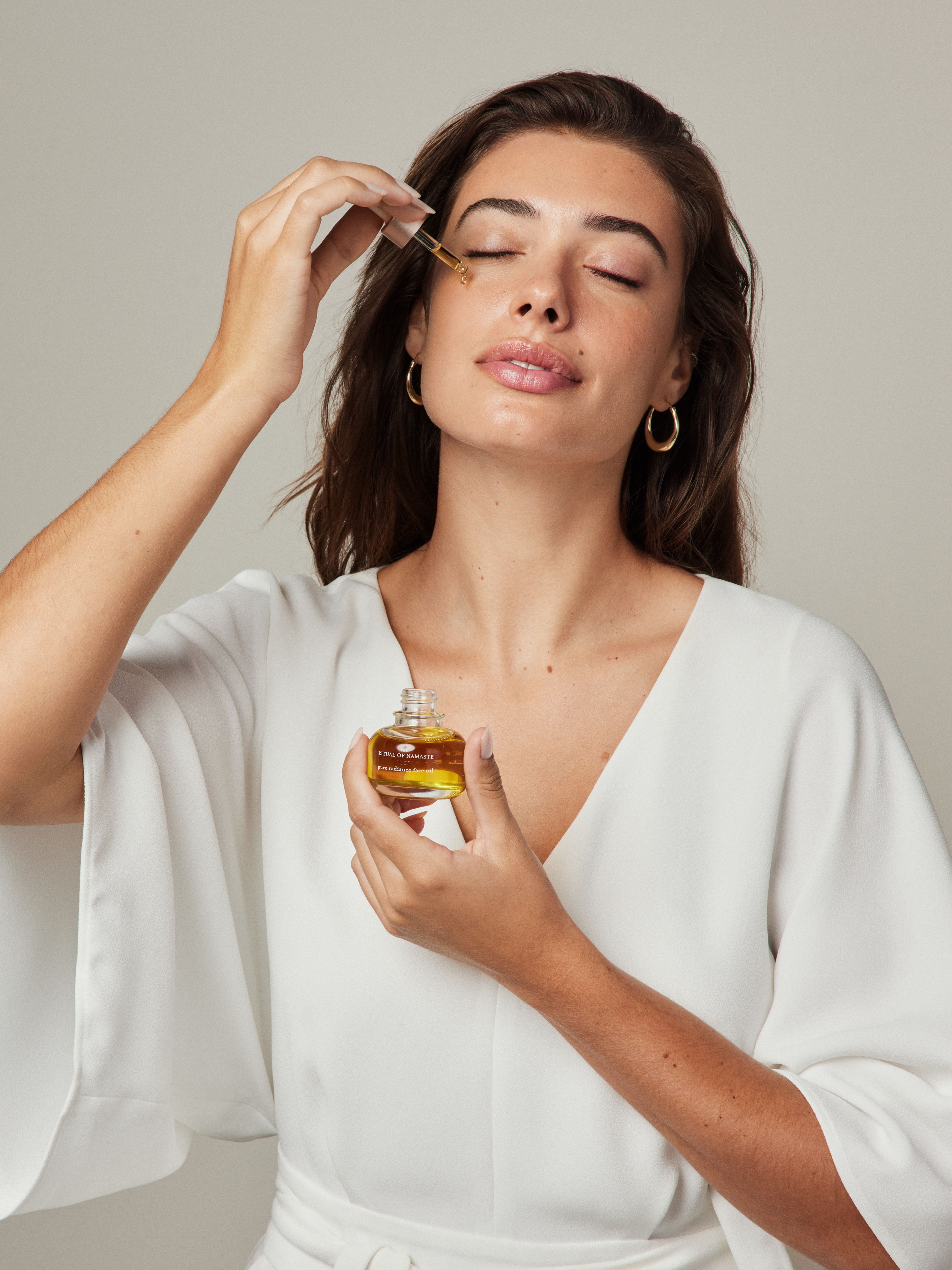 The Ritual of Namaste Anti-Ageing Face Oil Studio with Model and Product