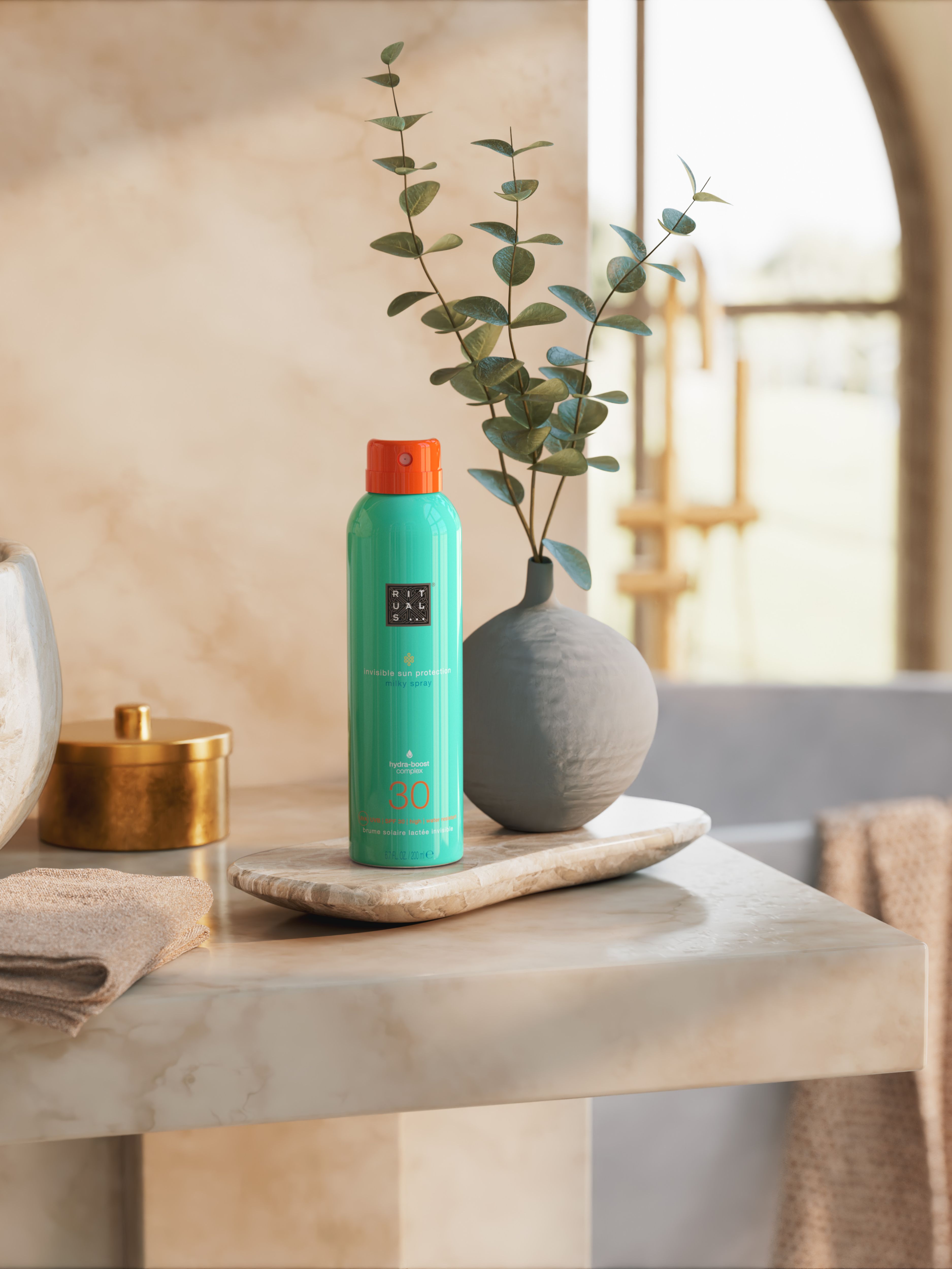 The Ritual of Karma Sun Protection Milky Spray 30 Lifestyle with Product