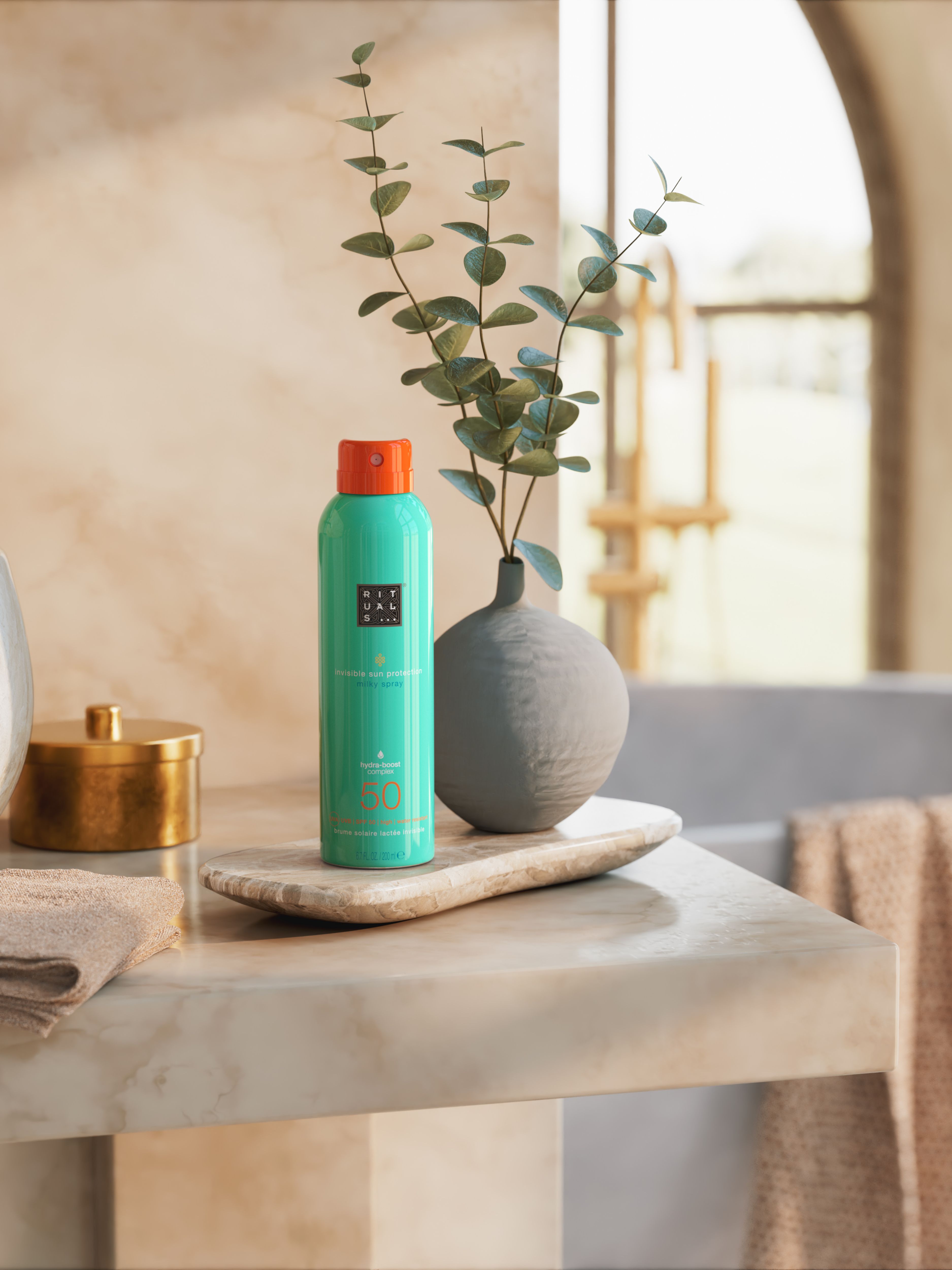 The Ritual of Karma Sun Protection Milky Spray 50 Lifestyle with Product