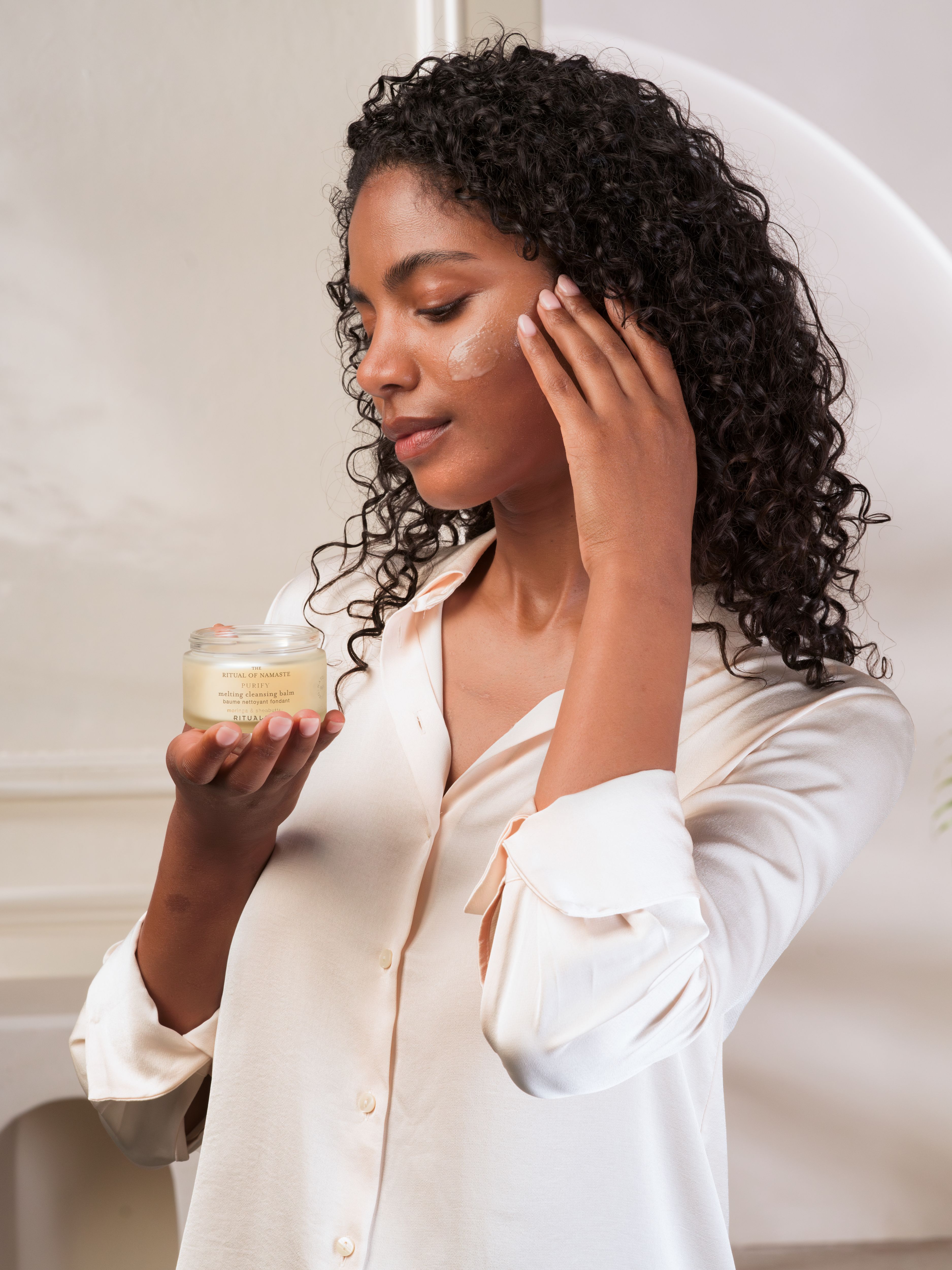 The Ritual of Namaste Melting Cleansing Balm Studio with Model and Product