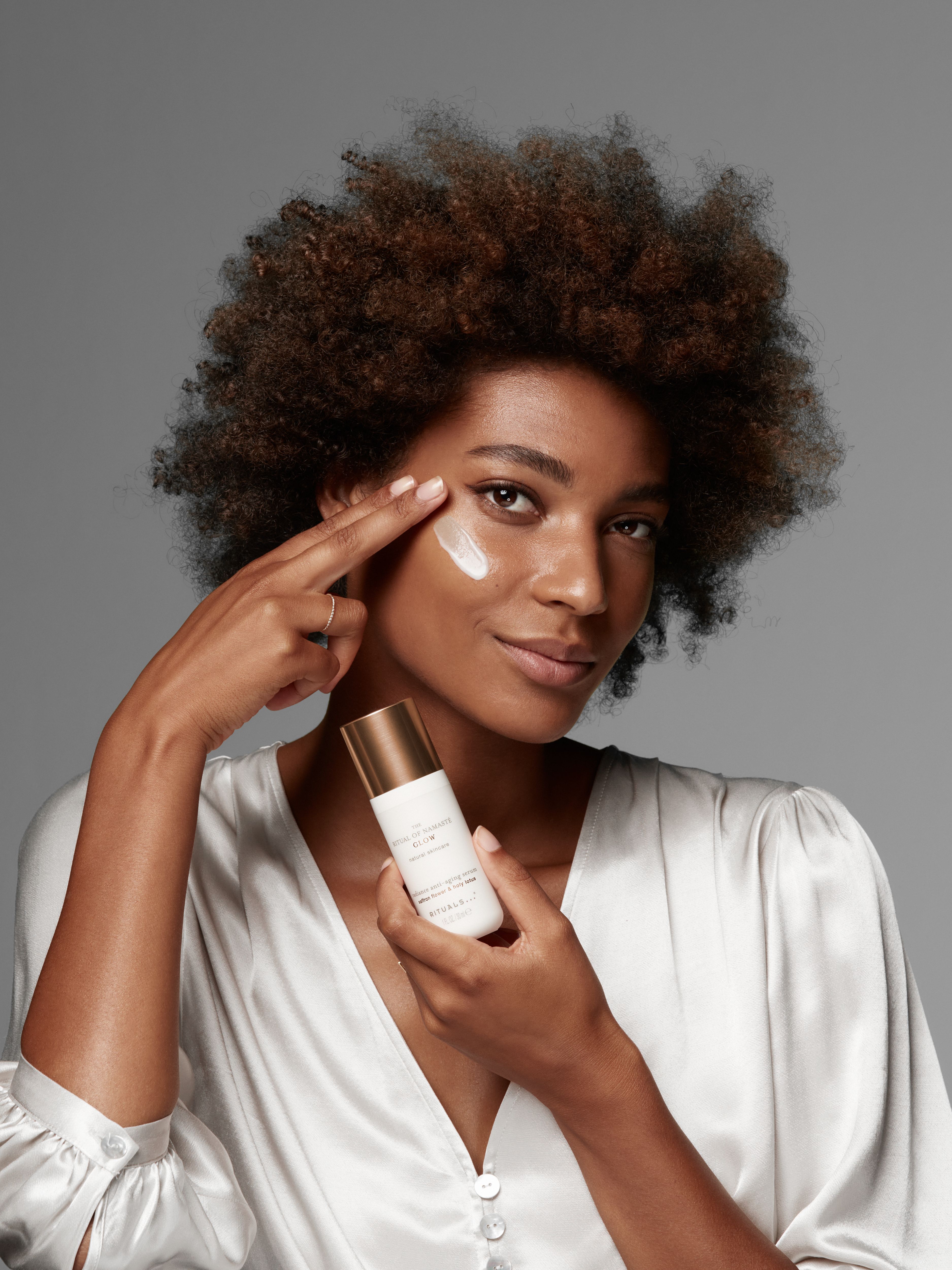 The Ritual of Namaste Glow Anti-Ageing Serum Studio with Model and Product